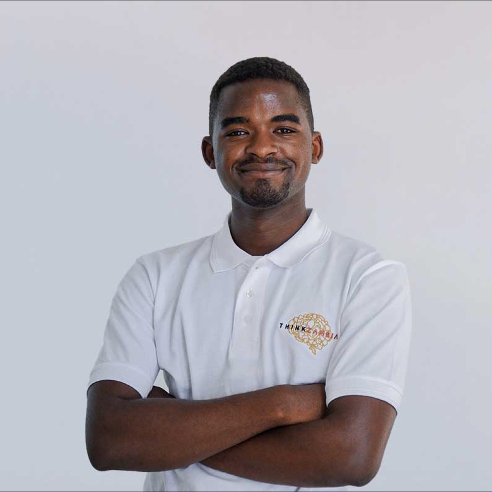 Chisanga wearing a Think Zambia Foundation polo shirt